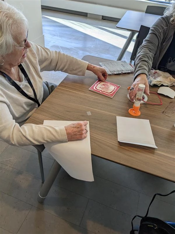 A couple seniors making crafts together at a table