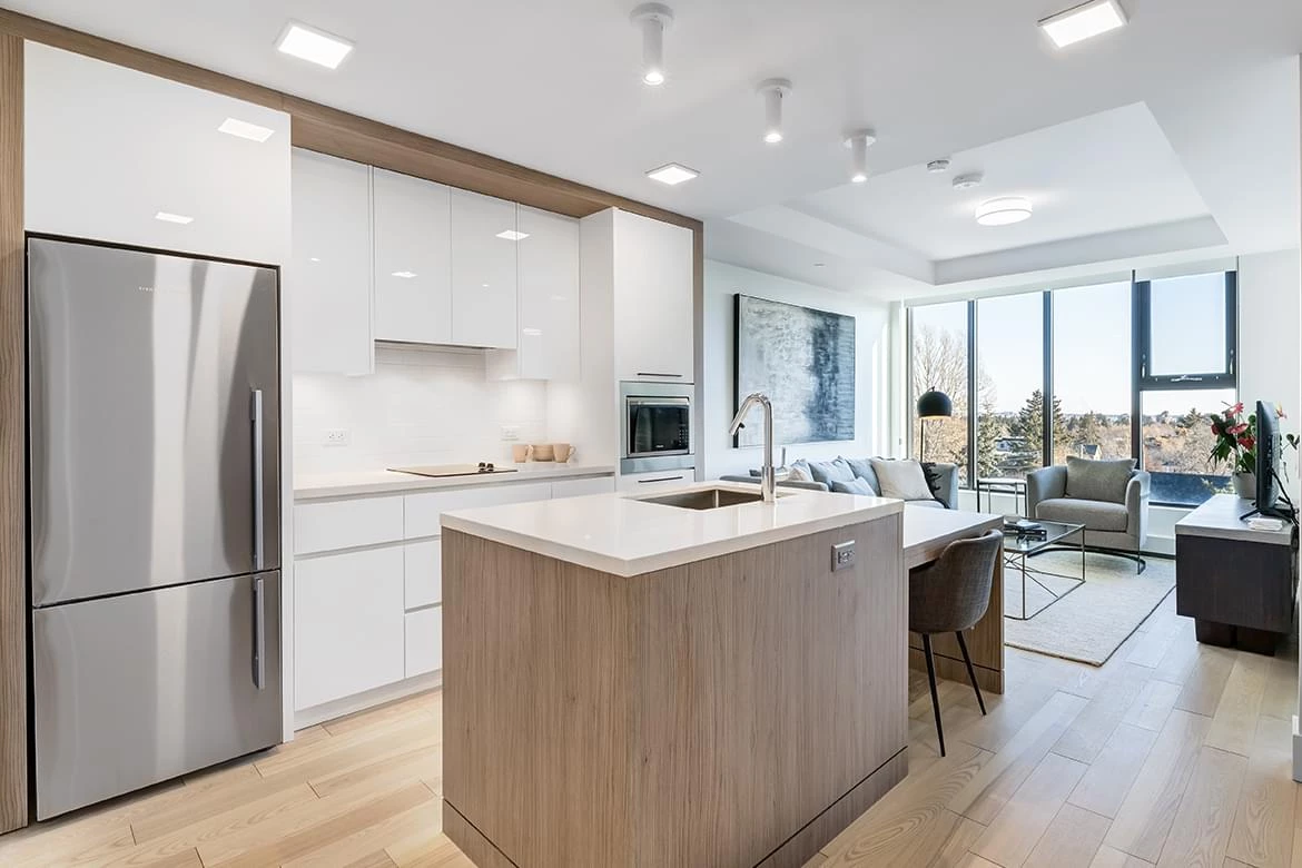 A kitchen and dining room view of a one bedroom apartment at The Edward