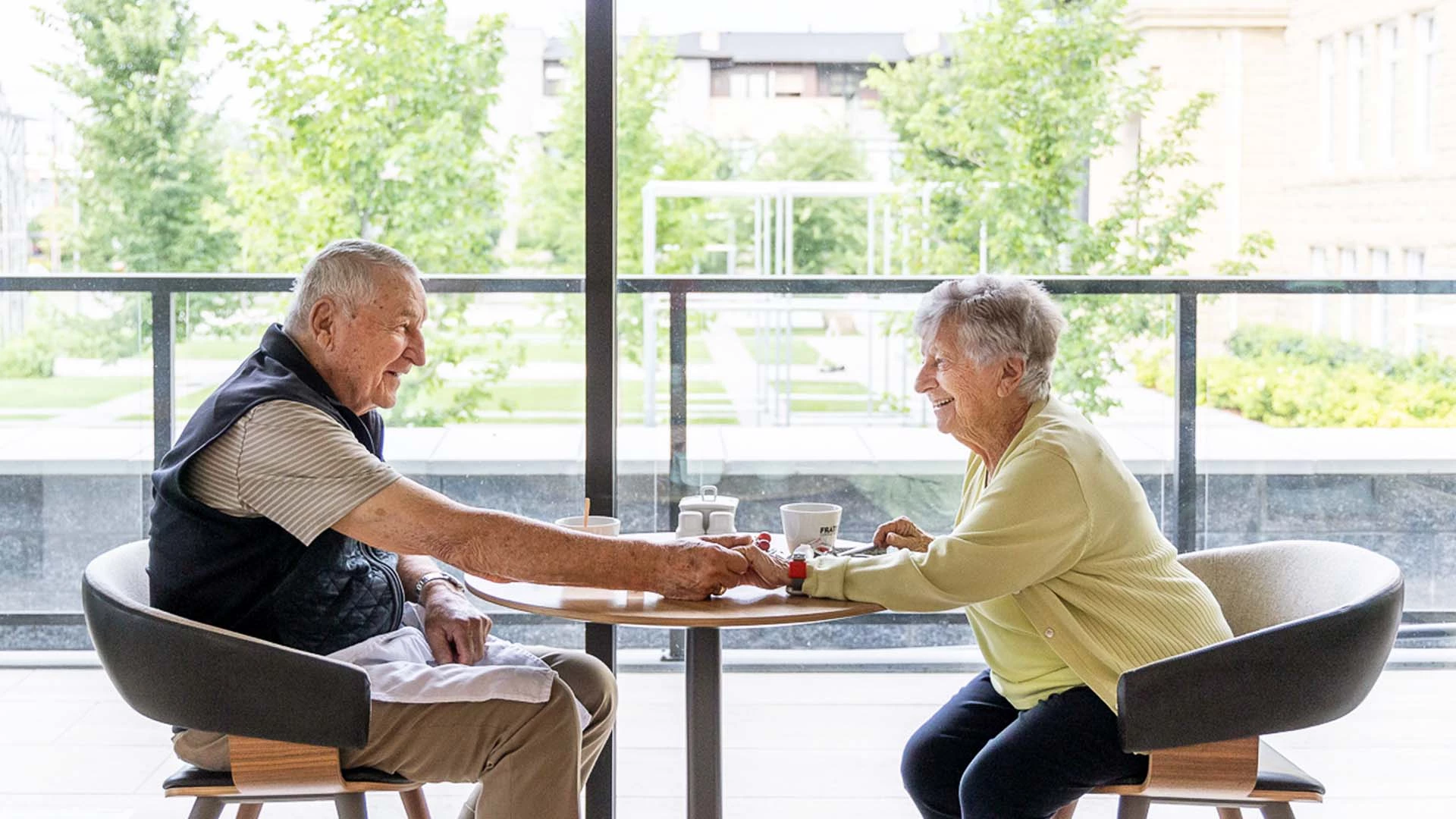 Could sitting across a round table holding hands