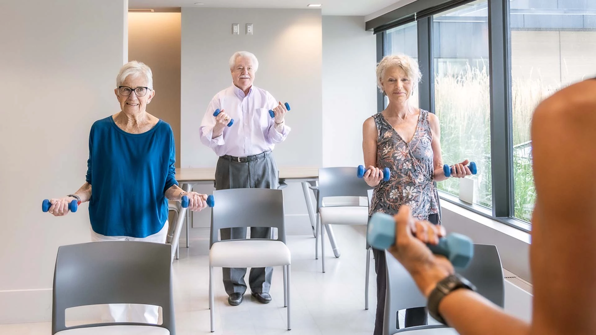 A group of seniors exercising with hand weights