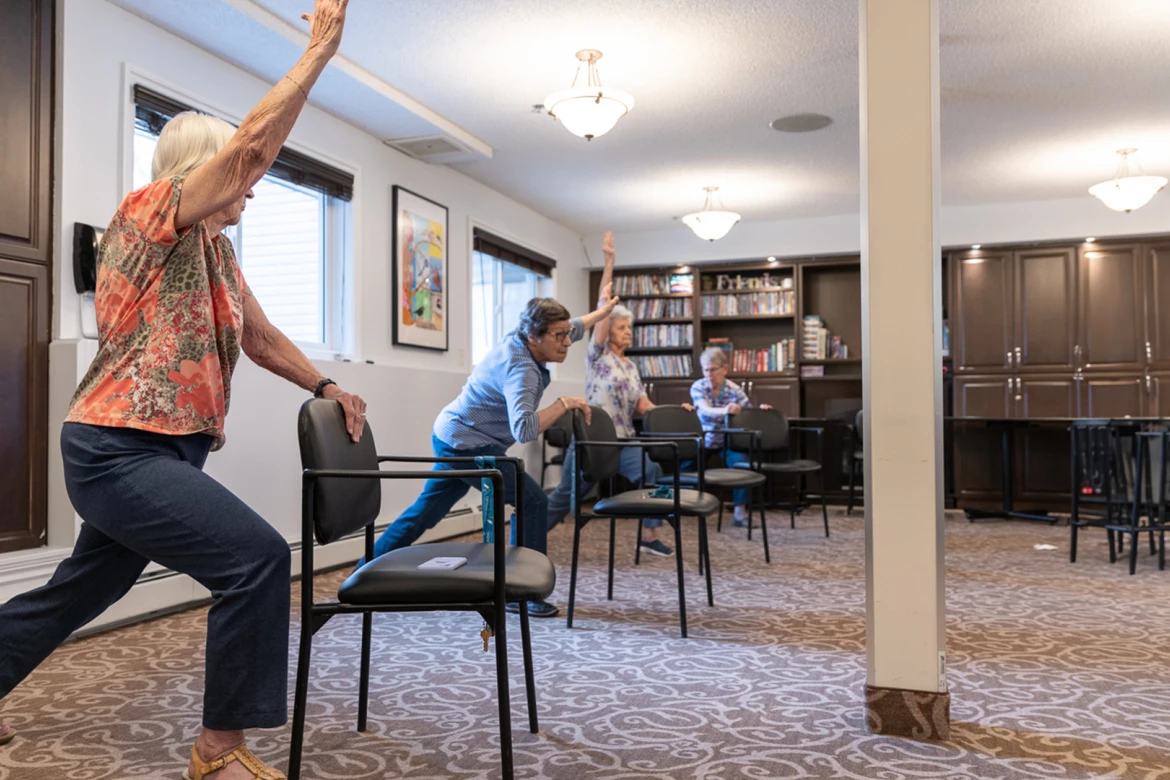 Seniors doing chair yoga