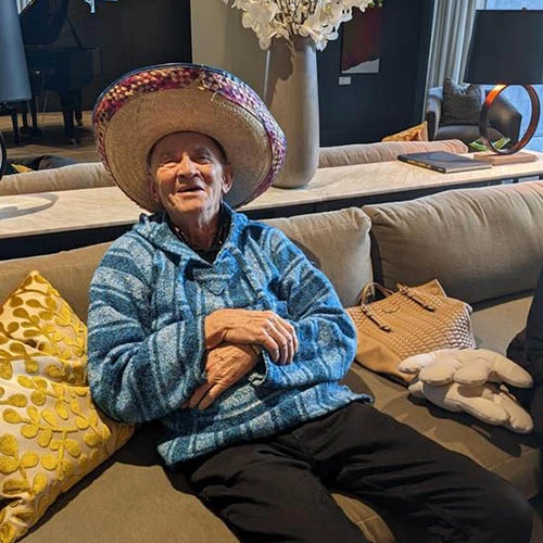 Man in sombrero smiling.