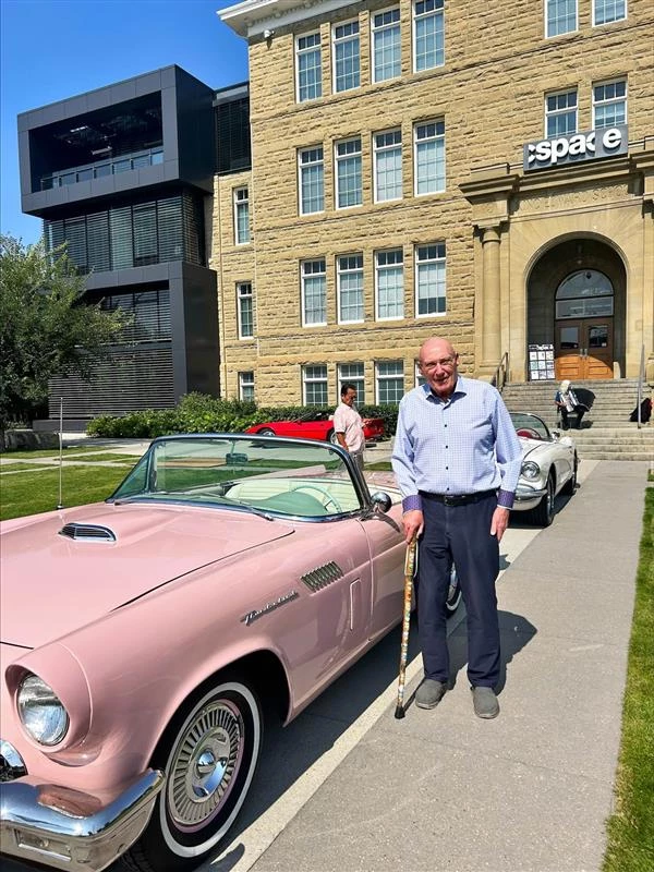 The Edward with some classic cars and residents in front of the building
